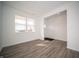 Bright living room featuring vinyl flooring, white walls, and large windows bringing in natural light at 7904 Magnolia St, New Palestine, IN 46163