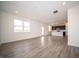 Open concept living room flowing into the kitchen with vinyl floors and natural light at 7904 Magnolia St, New Palestine, IN 46163