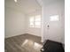 Bright living room with light gray wood floors, large windows and a welcoming entrance at 7904 Magnolia St, New Palestine, IN 46163