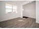 Bright living room with light gray wood floors, a large window and a welcoming entrance at 7904 Magnolia St, New Palestine, IN 46163