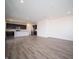 Open-concept living room showcasing hardwood floors and a modern kitchen at 7904 Magnolia St, New Palestine, IN 46163