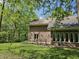 A view of a brick house exterior featuring multiple windows and access stairs, surrounded by greenery at 4257 Tattersall Dr, Plainfield, IN 46168
