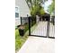 Private backyard featuring a black metal gate, potted flowers and easy access to outdoor space at 5441 E 17Th St, Indianapolis, IN 46218