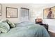Bedroom with green bedding, hardwood floors, and large window at 5441 E 17Th St, Indianapolis, IN 46218