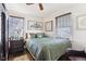 Cozy bedroom with a green comforter, hardwood floors, and two windows at 5441 E 17Th St, Indianapolis, IN 46218