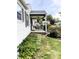 Quaint home with a covered front porch, outdoor seating, hanging plants and a manicured lawn at 5441 E 17Th St, Indianapolis, IN 46218
