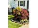 Landscaped front yard featuring a Japanese maple tree, decorative stones and hosta plants at 5441 E 17Th St, Indianapolis, IN 46218