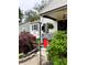 Cozy home featuring a decorative front yard, with lush plants and a charming bird feeding station at 5441 E 17Th St, Indianapolis, IN 46218