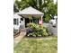 Charming home featuring a quaint front porch, beautiful landscaping and an American flag at 5441 E 17Th St, Indianapolis, IN 46218