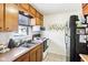 Charming kitchen featuring wood cabinets, stainless steel appliances, and a garden window at 5441 E 17Th St, Indianapolis, IN 46218