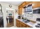 Kitchen features wood cabinets, a window view, and open access to dining area at 5441 E 17Th St, Indianapolis, IN 46218
