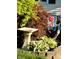 Landscaped garden featuring a bird bath, hostas, and decorative yard flag at 5441 E 17Th St, Indianapolis, IN 46218