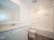 Clean bathroom with white vanity, shower/tub combo, and wood-look flooring at 1426 Bluebonnet Pl, Shelbyville, IN 46176