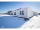 House exterior showcasing white siding and snowy yard at 1426 Bluebonnet Pl, Shelbyville, IN 46176