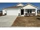 Charming single-story home with a white exterior, stone accents, and a well-manicured lawn at 1426 Bluebonnet Pl, Shelbyville, IN 46176