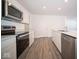 Modern kitchen with stainless steel appliances and white cabinetry at 1426 Bluebonnet Pl, Shelbyville, IN 46176