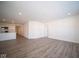 Open concept living room with kitchen access and wood-look floors at 1426 Bluebonnet Pl, Shelbyville, IN 46176