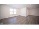 Open living room featuring wood-look floors and neutral walls at 1426 Bluebonnet Pl, Shelbyville, IN 46176