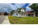 Side view of a quaint white two-story home with a small front porch and mature trees at 310 S Pleasant St, Edinburgh, IN 46124