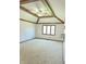Bright bedroom with a tray ceiling with beams, neutral carpet, and a large window at 4256 Bending Ln, Greenwood, IN 46143