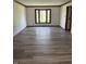 Empty dining room with wood trim and large window overlooking the front yard at 4256 Bending Ln, Greenwood, IN 46143