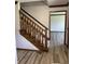 Carpeted staircase with wood banister leads to the upper level of the home at 4256 Bending Ln, Greenwood, IN 46143