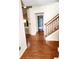 Spacious entryway with hardwood floors and staircase at 4835 Franklin Villas Dr, Indianapolis, IN 46237