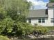 View of the back of the home, which has well-kept landscaping along a scenic body of water at 8520 Bison Woods Ct, Indianapolis, IN 46227