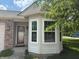 Close up of the front door and bay window of this lovely single Gathering home at 8520 Bison Woods Ct, Indianapolis, IN 46227