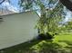 Side view of a home featuring vinyl siding, a small window, and manicured landscaping at 8520 Bison Woods Ct, Indianapolis, IN 46227