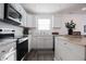 White shaker cabinets, stainless steel appliances, and marble countertops at 1501 Coen Ct, Columbus, IN 47201