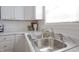 Clean kitchen with a double sink and white cabinetry at 1501 Coen Ct, Columbus, IN 47201