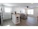 Open concept kitchen and living area with white cabinets and gray sofa at 1501 Coen Ct, Columbus, IN 47201