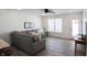 Spacious living room with gray sectional sofa and wood-look floors at 1501 Coen Ct, Columbus, IN 47201