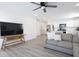 Living room with gray sofa, wood-look floors, and flat-screen TV at 1501 Coen Ct, Columbus, IN 47201
