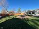 Spacious backyard featuring a hot tub on a wood deck, green grass, and a wood privacy fence at 562 Nelson Dr, Brownsburg, IN 46112