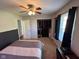 Bedroom with closet view, ceiling fan, and a bedside table; natural light from window at 562 Nelson Dr, Brownsburg, IN 46112