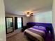 The bedroom has a queen bed with an attached accent headboard featuring purple LED lighting at 562 Nelson Dr, Brownsburg, IN 46112