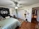 This bedroom has an accent tapestry, ceiling fan, closet, and wall decor at 562 Nelson Dr, Brownsburg, IN 46112