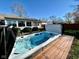 Backyard swim spa features clear water, deck surround, with view of the sunroom and fenced yard at 562 Nelson Dr, Brownsburg, IN 46112