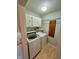 Practical laundry room featuring a washer, dryer, and built-in storage shelves at 562 Nelson Dr, Brownsburg, IN 46112