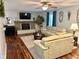Bright living room with a fireplace, mounted TV, and warm, neutral decor at 562 Nelson Dr, Brownsburg, IN 46112