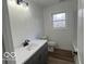 Well-lit bathroom with a clean vanity and sleek fixtures, enhanced by a bright window view at 11 S 1050 W, Jamestown, IN 46147