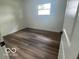 This bedroom offers natural light through the window and modern flooring, ideal for comfortable living at 11 S 1050 W, Jamestown, IN 46147