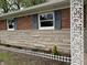 Home featuring a brick and stone facade, complemented by blue shutters and a well-maintained front garden at 11 S 1050 W, Jamestown, IN 46147