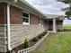 A house featuring a brick and stone facade with a well-manicured lawn and decorative fence at 11 S 1050 W, Jamestown, IN 46147