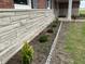 Lovely stone exterior with landscaped garden featuring a white picket fence and well-maintained lawn at 11 S 1050 W, Jamestown, IN 46147