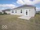 Cozy backyard features a simple patio area, rear door, and view of the house with large windows at 132 Velvet Hat Rd, Danville, IN 46122