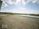 Expansive backyard view overlooking a tranquil pond with a fountain, offering a serene setting at 132 Velvet Hat Rd, Danville, IN 46122