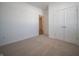 Well-lit bedroom with carpet floors and a view into the hallway at 132 Velvet Hat Rd, Danville, IN 46122